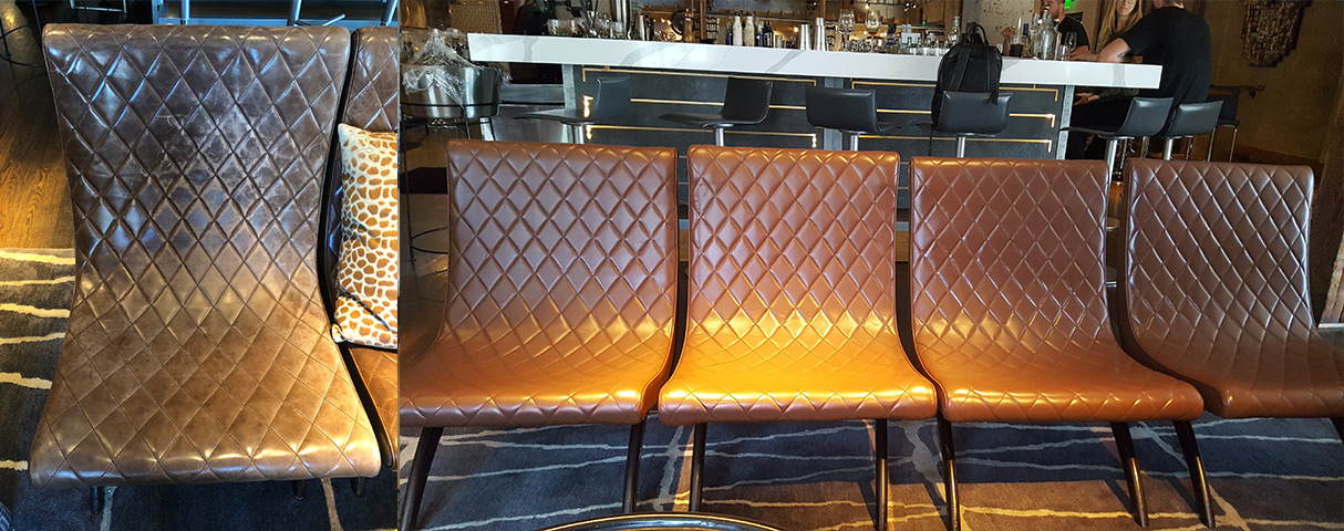 A red leather couch on a tile floor